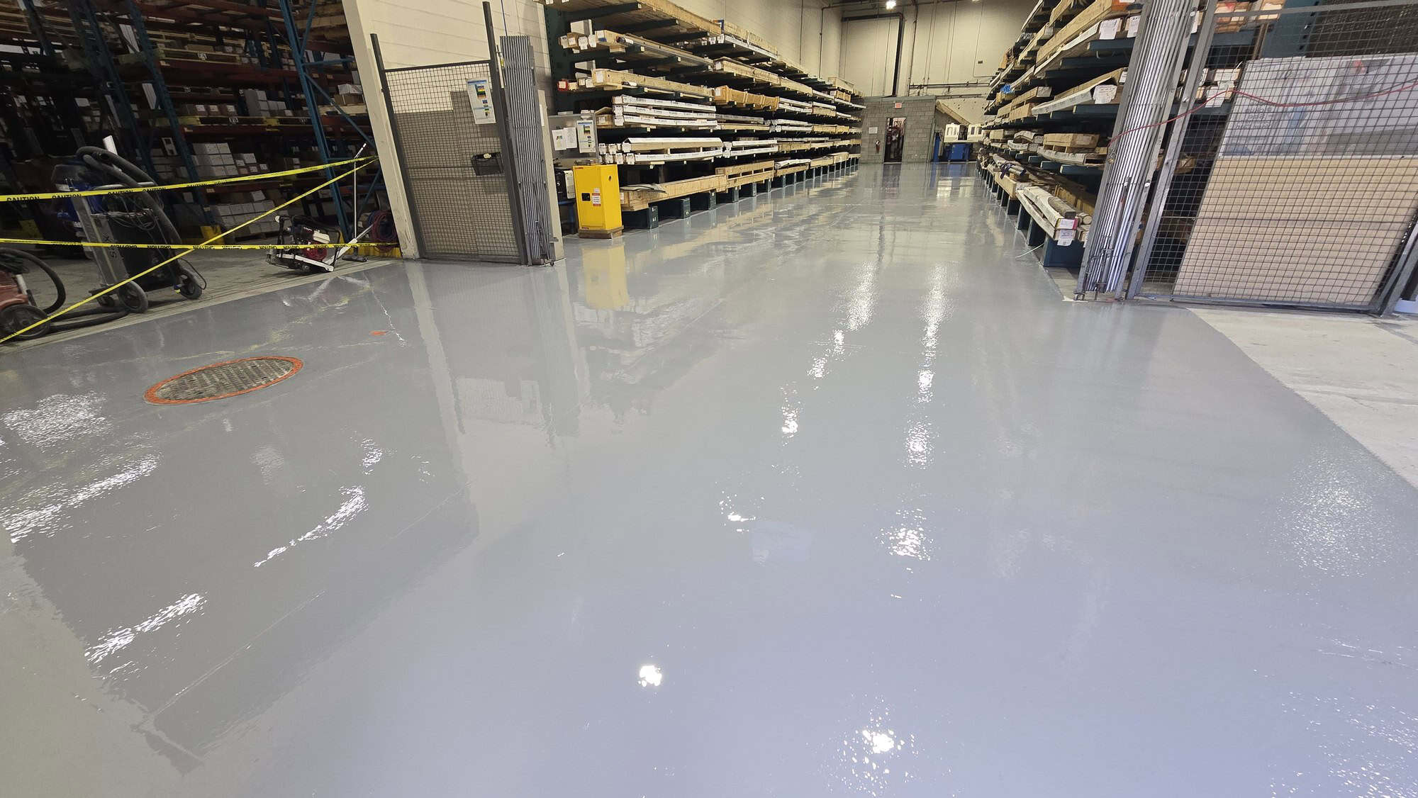 Freshly installed epoxy coated concrete slab in a warehouse aisle, Greater Montreal