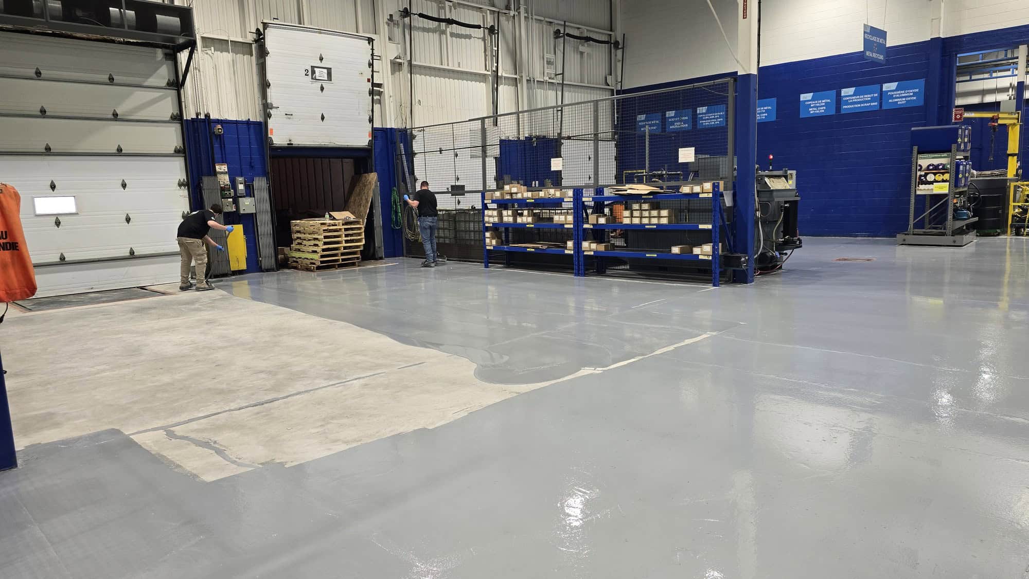 First coat of epoxy going down on a prepared industrial concrete slab, Vaudreuil-Dorion