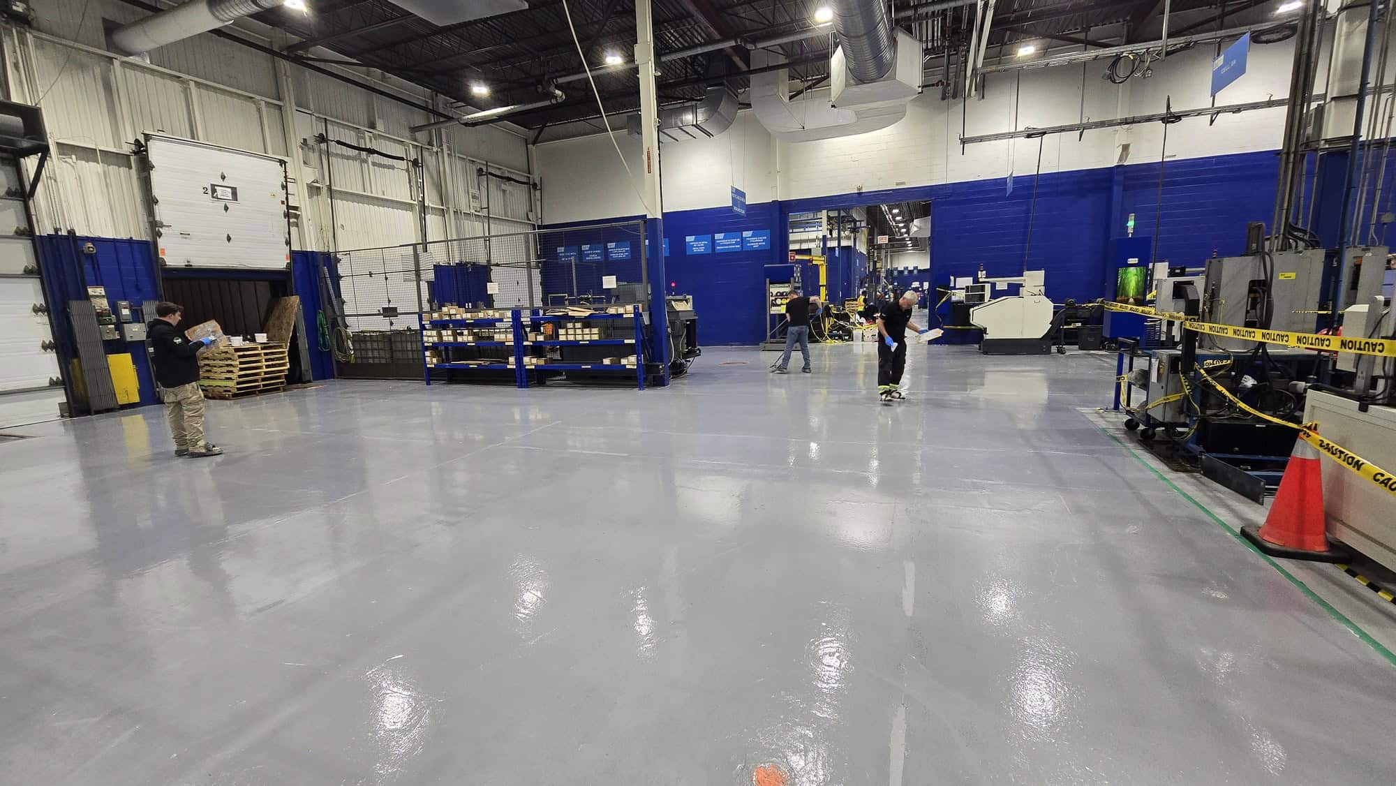 Second coat of epoxy applied to an industrial concrete floor in the Montreal area