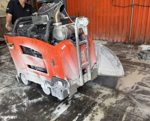 Concrete sawing contractor cutting an industrial slab with a walk-behind saw in Montreal